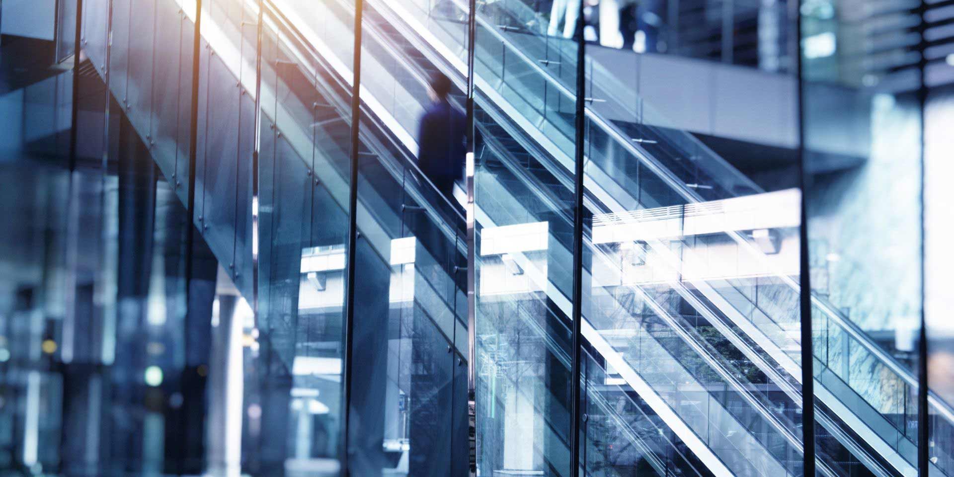 Man on ascending building escalator