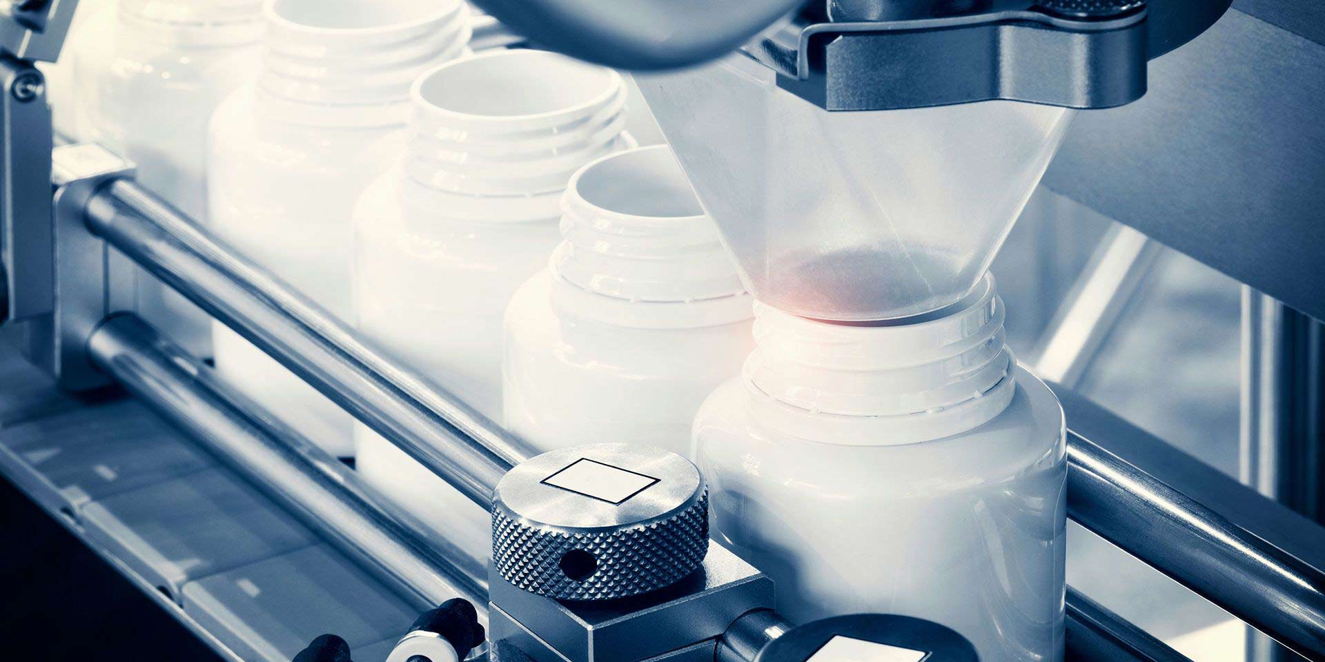 machine with four white plastic round boxes